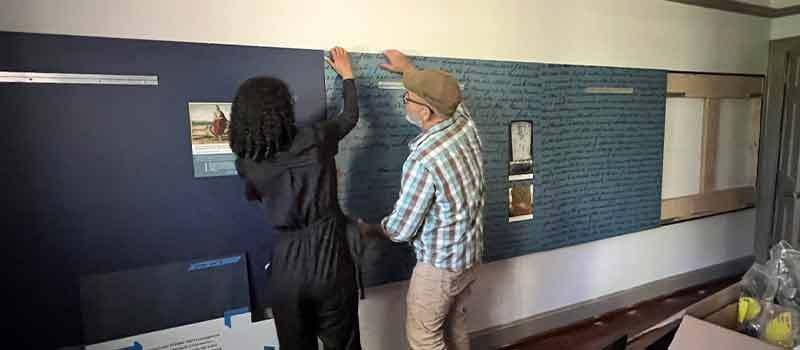 Two Staff Members Installing Exhibit at Francis Land House