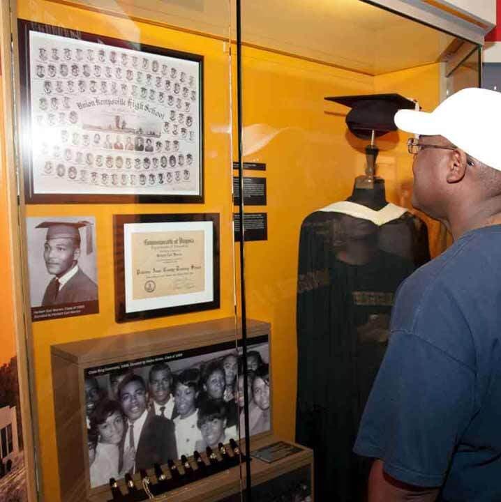 Visitor Looking at Glass Display of High School Photos
