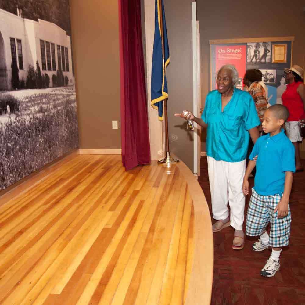 Grandma and Grandson Looking at the Old School Stage